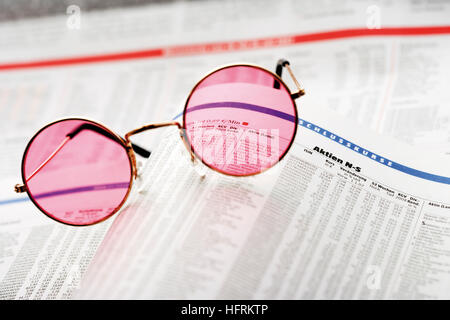 Rosafarbene Brille auf einer Finanzzeitung Stockfoto