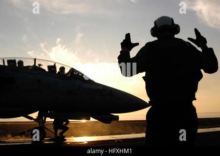 060102-N-8163B-006 Persischen Golf (2. Januar 2006) Ð eine Flugzeugabfertigung Petty Officer leitet eine f-14 Tomcat bis das Katapult auf dem Flugdeck an Bord der Flugzeugträger der Nimitz-Klasse USS Theodore Roosevelt (CVN-71). Roosevelt und eingeschifften Carrier Air Wing acht (CVW-8) sind im Gange auf eine regelmäßige Bereitstellung Gefahrenabwehr Operationen durchführen. Foto: U.S. Navy des Fotografen Mate 3. Klasse Eben Boothby (freigegeben) US Navy 060102-N-8163B-006 eine Flugzeugabfertigung Petty Officer leitet eine f-14 Tomcat bis das Katapult auf dem Flugdeck an Bord der Flugzeugträger der Nimitz-Klasse Stockfoto