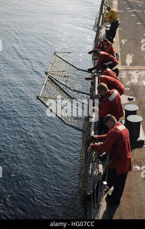 111018-N-XQ375-322 Arabisches Meer (18. Oktober 2011) Segler erhöhen die Netze auf dem Flugdeck der geführte Flugkörper-Zerstörer USS Mitscher (DDG-57), nach der Durchführung der Flugbetrieb. Mitscher bereitgestellt wird, in die USA 5. Flotte Aufgabengebiet maritimer Sicherheitsoperationen und Theater Sicherheitsbemühungen Zusammenarbeit zu unterstützen. (Foto: U.S. Navy Mass Communication Specialist 3. Klasse Deven B. King/freigegeben) US Navy 111018-N-XQ375-322 Segler erhöhen die Netze auf dem Flugdeck der geführte Flugkörper-Zerstörer USS Mitscher (DDG-57) nach der Durchführung des Fluges Stockfoto