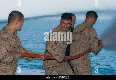 120104-N-DX615-079 Golf von ADEN (4. Januar 2012) Marine CPL. Joshua Frederick schreit zur Linderung der Nozzleman während eines Schlauches Umgang mit Bohrmaschine an Bord der amphibischen Angriff Schiff USS Makin Island (LHD 8). Makin Island, mit eingeschifften Marines, die 11. Marine Expeditionary Unit zugeordnet (11. MEU) wird bereitgestellt, maritimer Sicherheitsoperationen und Sicherheitsbemühungen Zusammenarbeit Theater in den USA unterstützen 5. Flotte Aufgabengebiet. (Foto: U.S. Navy Mass Communication Specialist 2. Klasse Alan Gragg/freigegeben) US Navy 120104-N-DX615-079 Marines üben richtigen Schlauch Umgang mit Techniken Stockfoto