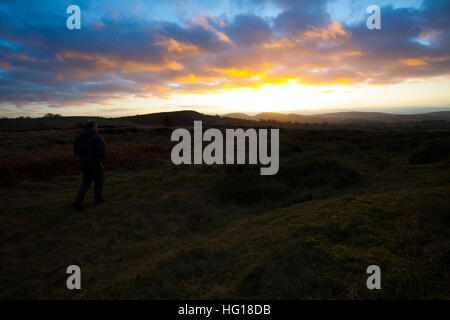 Sonnenuntergang über den Clwydian Hügeln in der Ferne als Wanderer genießt die Aussicht vom Berg Halkyn, Flintshire Stockfoto