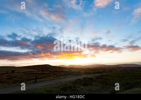 Sonnenuntergang über den Clwydian Hügeln in der Ferne als Wanderer genießt die Aussicht vom Berg Halkyn, Flintshire Stockfoto