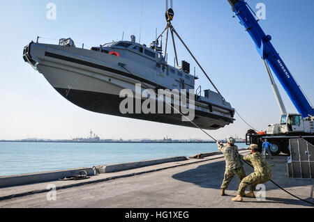 140210-N-IZ292-113 NAVAL SUPPORT Aktivität BAHRAIN (10. Februar 2014) Elektroniker / 2. Klasse Andrew Garcia, rechts, und der Bootsmann Mate 2. Klasse Chris Stout Griff eine Linie während einer Küstenstadt Befehl Boot, vom Pier in Vorbereitung gehoben wird, ins Wasser zu senken. (Foto: U.S. Navy Mass Communication Specialist 1. Klasse Felicito Rustique/freigegeben) US Navy Küsten Befehl Boot am Kran in Bahrain im Jahr 2014 Stockfoto