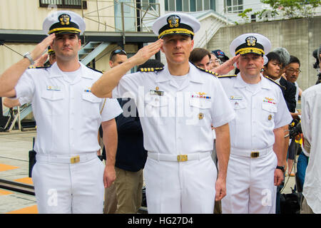 150518-N-TE278-104 YOKOSUKA, Japan (18. Mai 2015) Rear Admiral John Alexander, Kommandant, Schlacht zwingen, 7. US-Flotte, rechts, Captain Timothy Kuehhas, Kommandierender Offizier der Flugzeugträger der Nimitz-Klasse USS George Washington (CVN-73), Center und Lt. Alex Glass, Commander, Task Force (CTF) 70 Flagge Hilfe, Gruß der nationalen Fähnrich während morgen Farben vor dem Abflug Washingtons für seine 2015-Patrouille. George Washington und seine eingeschifften Geschwader Carrier Air Wing (CVW) 5, bieten eine kampfbereit Kraft, die schützt und verteidigt die kollektive maritime Interessen der USA und ihrer Verbündeten und pa Stockfoto