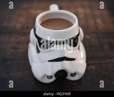 Storm Trooper Helm Becher gefüllt mit Tee auf einem dunklen Holztisch. Stockfoto