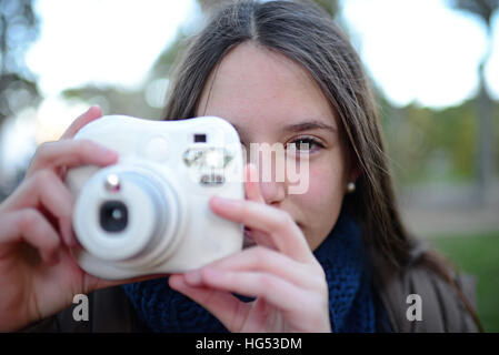 Süße Teenager mit einer Sofortbild-Kamera Stockfoto