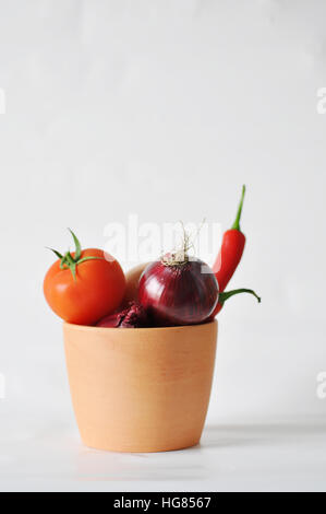 Tomaten, rotem Papier und Zwiebeln auf einem weißen Hintergrund Nahaufnahme der Reflexion Stockfoto