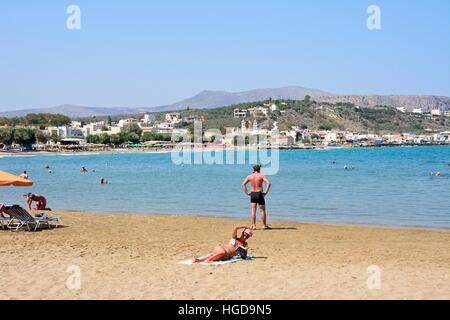 Entspannende Touristen am Strand mit Blick auf die Berge, Kalyves, Kreta, Griechenland, Europa. Stockfoto