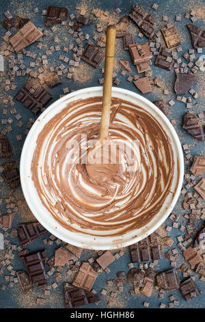 Leere Schokoladenkuchen Rührschüssel mit Schokolade Brocken und Pulver auf Schiefer Stockfoto