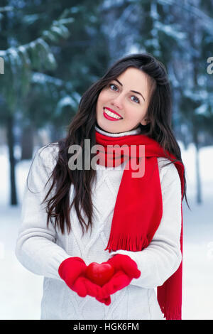 Mädchen im Winterwald mit Herz Stockfoto