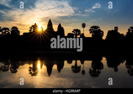 Angkor Wat Tempel in dramatischen Sonnenaufgang Sunburst im Wasser reflektiert Stockfoto