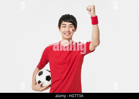 Porträt der jungen koreanischen Cheerleader Mann lächelnd Stockfoto