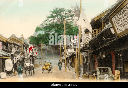 Japan, Yokohama. Alte Ansichtskarte Hand gefärbt. Motomachi Einkaufsstraße mit den Schritten zum Schrein am Ende der Straße. um 1910. Stockfoto