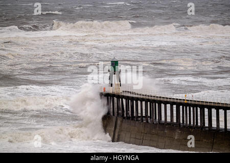 Großbritannien Wetter. Whitby, North Yorkshire, UK. 13. Januar 2017. Raue See brechen über die schützende Piers Whitby Hafen verursacht durch starke Winde in Nordost-England. Copyright Ian Wray Stockfoto