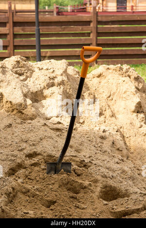 Schaufel in einen Haufen Sand stecken Stockfoto