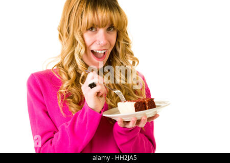 Eine attraktive blonde Frau, die einen Stück Kuchen zu genießen Stockfoto