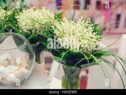 schöne Blumensträuße von Lily Tal auf Hochzeitstisch Stockfoto