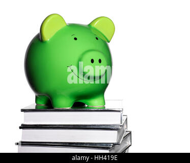 Green Piggy Bank an der Spitze einen Stapel Bücher Stockfoto