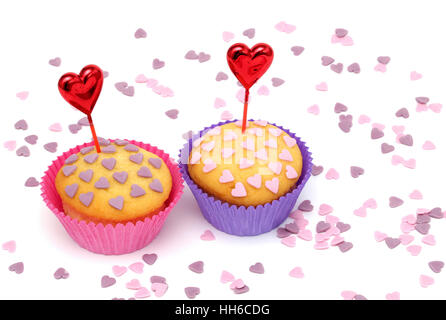 Zwei Cupcakes mit kleinen rosa und lila Herzen Stockfoto