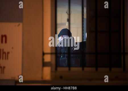 Dresden, Deutschland. 18. Januar 2017. Ein Polizist abgebildet in einem Unternehmen und private Räumlichkeiten während einer großen Polizei Betrieb Targeting eine mutmaßliche internationale Bande von Diebe in Dresden, Deutschland, 18. Januar 2017. Mehr als 30 Objekte wurden durchsucht. Die föderale Polizei sagen, dass mehrere hundert Offiziere eingesetzt wurden, unterstützt von Beamten Zoll- und Sachsen State Office of Criminal Investigations. Foto: Arno Burgi/Dpa-Zentralbild/Dpa/Alamy Live-Nachrichten Stockfoto