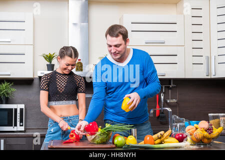 Junge Paare, die Spaß in der Küche Stockfoto