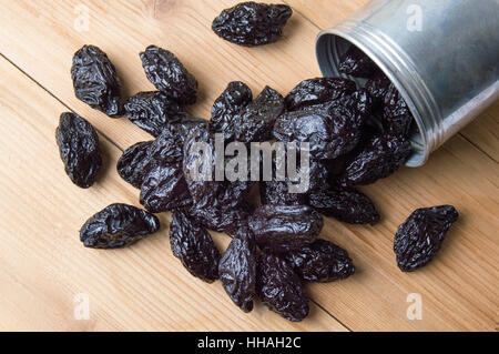 Getrocknete Pflaumen in einer Metalldose auf dem Tisch Stockfoto