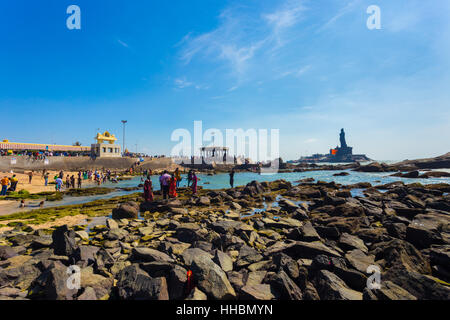 Indische Touristen Schwimmen im flachen Meerwasser in der Nähe von Thiruvalluvar Statue und 16 vierbeinigen Mandap-Pavillon im südlichsten Stadt Stockfoto