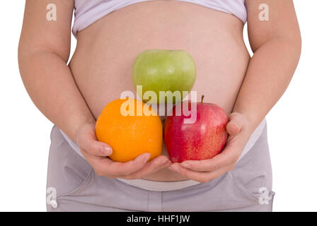 Schwangere Frau mit zwei Äpfel und Orangen isoliert mit Pfad Stockfoto