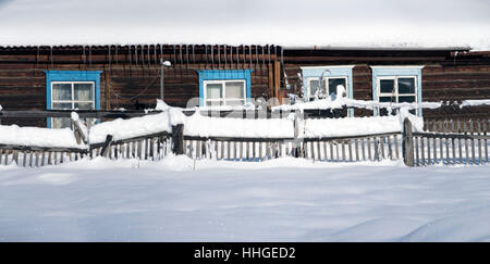 Verschneiter Zaun auf dem Lande. Der Schnee glitzert in der Sonne. Ländliche Winter-Szene.  Panorama, HDR - hoher Dynamikbereich. Stockfoto