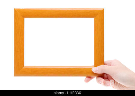 Hand, die aus Holz Bilderrahmen auf weißem Hintergrund Stockfoto