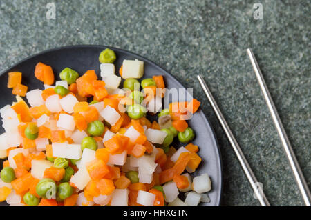 Gekochtes Gemüse auf einem Teller mit Stäbchen Stockfoto