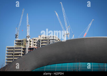 Neue Hochhäuser im Bau hinter London Aquatics Centre auf der Queen Elizabeth Olympic Park in Stratford, im Osten von London. Die London Legacy Development Corporation hat einen ehrgeizigen Plan, das Gebiet rund um die Website für die Olympischen Spiele 2012 zu regenerieren dargelegt eine Mischung aus wohnen, Unternehmen und öffentlichen Einrichtungen zu schaffen. Stockfoto