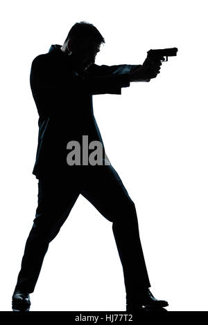 ein kaukasischer Spion krimineller Polizist Detektiv Mann mit dem Ziel schießen Pistole in voller Länge Silhouette im Studio isoliert weißen Hintergrund Stockfoto