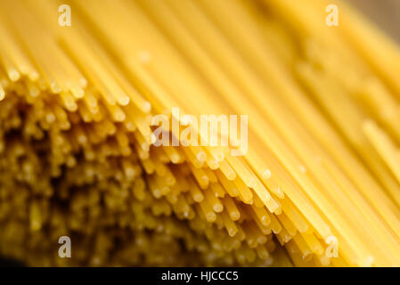 Auszug aus trocken und ungekochte Spaghetti mit flachen Enden im Mittelpunkt Stockfoto