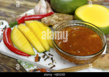 Schüssel mit hausgemachten Frsh Mango-Chutney auf alten Holztisch Stockfoto