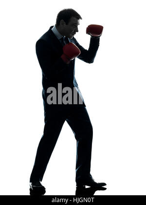 ein kaukasischer Geschäftsmann mit Boxhandschuhen Silhouette Studio isoliert auf weißem Hintergrund Stockfoto