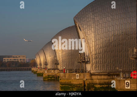 Die Thames Barrier in Woolwich Kent. im Abendlicht. mit dem Flugzeug kommen in der London City airport Stockfoto