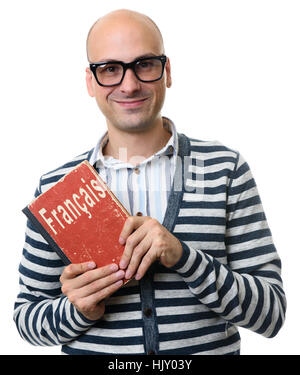 Glatze Mann hält ein Lehrbuch oder Wörterbuch. Französische Lernkonzept Stockfoto