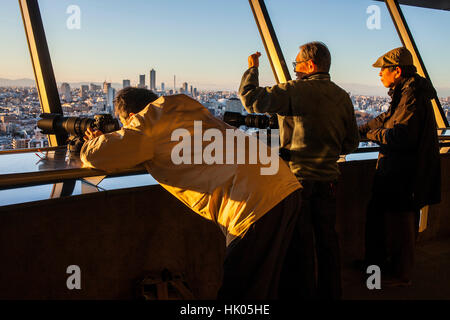 Fotografen auf der Spitze eines Wolkenkratzers, Aufnahmen von der Skyline bei Sonnenuntergang Tokyo, Japan Stockfoto