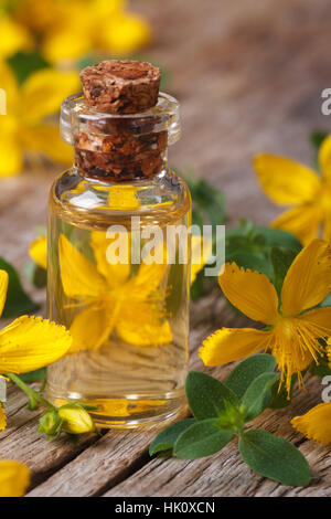 Öl aus den Blüten von Johanniskraut in einem Glas Flasche Makro vertikalen Stockfoto