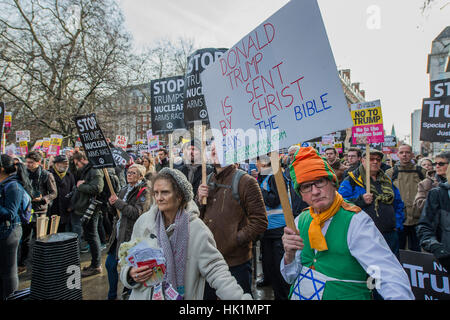 London, UK. 4. Februar 2017. Außerhalb der US-Botschaft behauptet dieser Mann seine Plakat bezieht sich auf die Appocalypse, aber es ärgert viele der Demonstranten - ein Marsch gegen Rassismus sowie das Verbot (gegen die Einwanderung aus bestimmten Ländern in die USA) zu verbieten wird von stehen bis zum Rassismus organisiert und unterstützt durch Anschlag des Krieges und mehrere Gewerkschaften. Es erklärt mit einer Kundgebung in der US-Botschaft am Grosvenor Square und landete in Whitehall vor Downing Street. Tausende von Menschen aller Rassen und jeden Alters besucht. 4. Februar 2017 London. Bildnachweis: Guy Bell/Alamy Live-Nachrichten Stockfoto