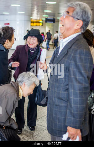 Betrunkene, Freunde verabschieden, in Shinjuku Bahnhof, Tokio, Japan. Stockfoto