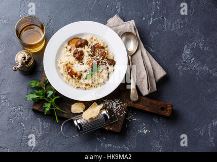 Risotto mit Steinpilzen auf dunklen Stein Hintergrund Stockfoto