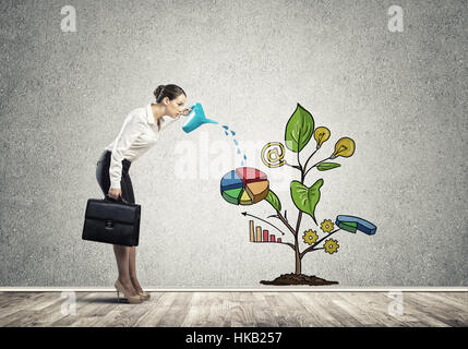 Junge Geschäftsfrau in leeren Raum Gießen gezeichnete Wachstumskonzept mit can Stockfoto
