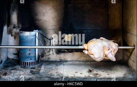 Kochen und zubereiten von rohen Brathähnchen vom Grill mit Holzkohle und Briketts in der professionellen Steakhaus oder Grill-restaurant Stockfoto