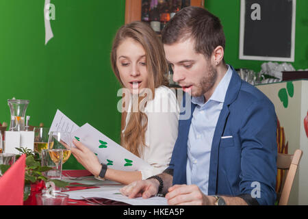 Surprised Ausdruck eines Paares im Menü eines Gourmetrestaurants speisen auswählen Stockfoto