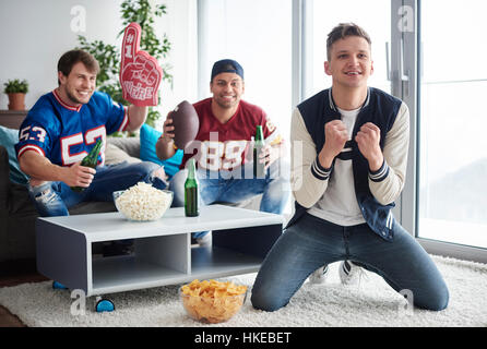 Junge Männer beobachten amerikanischen Fußball-Wettbewerb Stockfoto