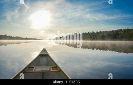 Kanutour am Morgen.  Brillante und leuchtende Mitte Sonnenschein Sommermorgen, eine Kanu mitten im ruhigen, ruhige und friedliche Corry See paddeln. Stockfoto