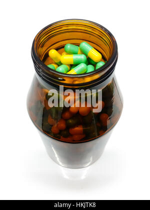 Kapseln und Medizin-Flasche, gelb-grüne Pillen Stockfoto