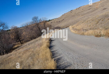 Feldweg, der windet sich durch einige Hügel in Wyoming Stockfoto